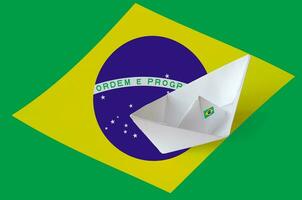 Brazil flag depicted on paper origami ship closeup. Handmade arts concept photo
