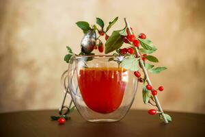 Prepared hot drink from ripe goji berries in a glass cup photo