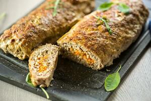 Cooked minced meatloaf with vegetable filling inside. photo