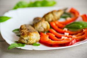 Pieces of fried hake fish in a plate with pepper photo