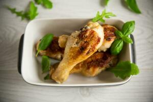 grilled chicken legs fried with spices and herbs photo