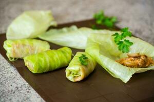 Raw cabbage rolls stuffed with meat and mushrooms photo