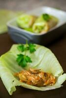 Raw cabbage rolls stuffed with meat and mushrooms photo