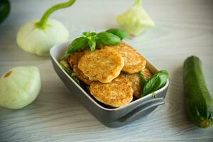 fried vegetable pancakes from squash and zucchini with herbs photo