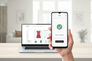 Phone online payment. Laptop and e-commerce website in background. Digital transaction showcasing seamless online shopping and secure electronic payments photo