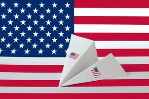 United States of America flag depicted on paper origami airplane. Handmade arts concept photo