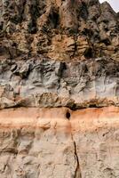 a rock face with orange and brown colors photo