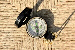 a compass on a woven surface photo