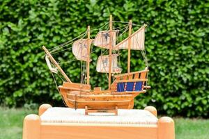 a wooden model of a ship on a table photo