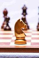 chess pieces on a chess board with a horse photo