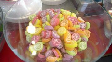 Beautiful colored jelly rolls and sugar in a glass bowl. video