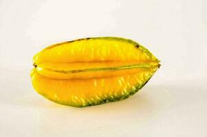 a yellow star fruit on a white background photo