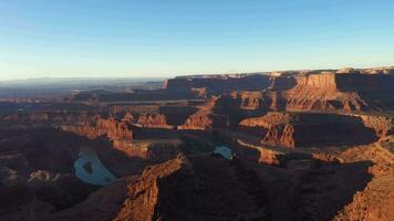 Dead Horse Point State Park at Sunrise. Colorado River, Red Canyon and Clear Sky. Utah, USA. Aerial View. Drone Flies Forward, Tilt Down video
