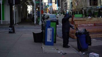 NEW YORK CITY, USA - JANUARY 23, 2021 Janitor Wearing Mask is Cleaning Street Garbage in Midtown Manhattan video