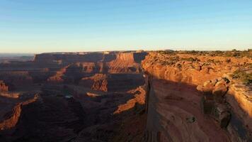 Dead Horse Point State Park at Sunrise. Colorado River, Red Canyon and Clear Sky. Utah, USA. Aerial View from Meander Overlook. Drone Flies Forward video