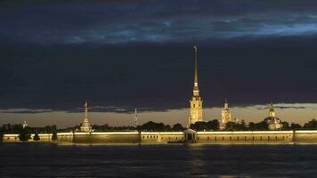 Illuminated Peter and Paul Fortress and Lakhta Skyscraper at Summer Night. Neva River. Saint-Petersburg, Russia. Motion Panning Time Lapse video