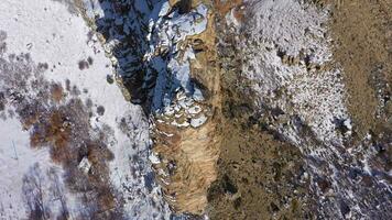 Castle Gate Spire and Mountains on Sunny Winter Day. Utah, USA. Aerial View. Drone Flies Downwards, Tilt Up video