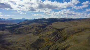 Red Hills of Clay, Mountains, and Larches in Autumn. Aerial View. Mars. The Altai Mountains, Russia. Aerial Hyper Lapse, Time Lapse video