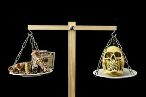 a skull and money on a scale photo