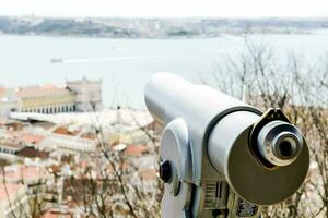a telescope on top of a hill overlooking the city photo