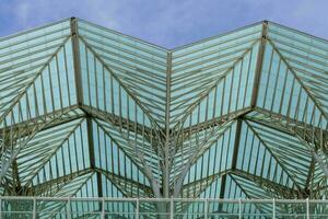 the glass roof of a building with a triangular design photo