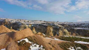Cappadocia in Winter on Sunny Day. Snowy Hills and Pillars. Turkey. Aerial View. Drone Flies Forward at Low Level video