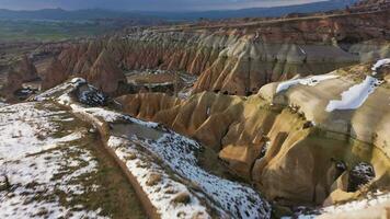 Cappadocia in Winter on Sunny Day. Snowy Hills and Pillars. Turkey. Aerial View. Drone Flies Forward, Tilt Up. Reveal Shot video