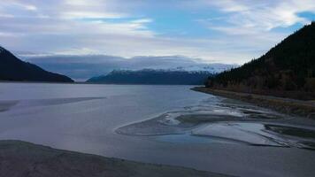 Turnagain Arm, Snow-Capped Mountains and Seward Highway on Autumn Day. Alaska, USA. Aerial View. Drone Flies Backwards and Upwards video