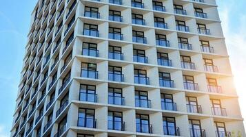 Condominium and apartment building with  symmetrical modern architecture in the city downtown. photo