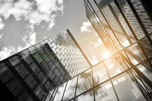 Modern architectural details. Modern glass facade with a geometric pattern. Contemporary corporate business architecture. Red sun on horizon. Black and white toned image. photo
