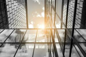 Modern architectural details. Modern glass facade with a geometric pattern. Contemporary corporate business architecture. Red sun on horizon. Black and white toned image. photo