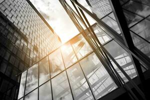 Modern architectural details. Modern glass facade with a geometric pattern. Contemporary corporate business architecture. Red sun on horizon. Black and white toned image. photo