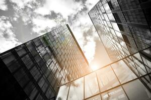 Modern architectural details. Modern glass facade with a geometric pattern. Contemporary corporate business architecture. Red sun on horizon. Black and white toned image. photo