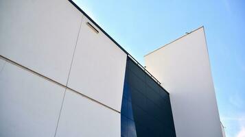 Glass building with transparent facade of the building and blue sky. Structural glass wall reflecting blue sky. Abstract modern architecture fragment. Contemporary architectural background. photo