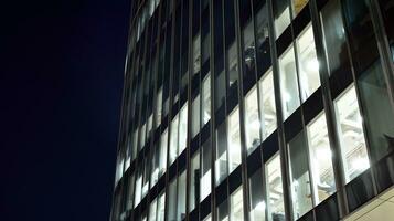 Pattern of office buildings windows illuminated at night. Glass architecture ,corporate building at night - business concept. photo