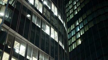 Pattern of office buildings windows illuminated at night. Glass architecture ,corporate building at night - business concept. photo