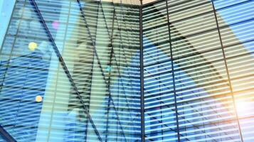 Glass building with transparent facade of the building and blue sky. Structural glass wall reflecting blue sky. Abstract modern architecture fragment. Contemporary architectural background. photo