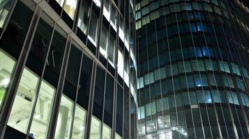Pattern of office buildings windows illuminated at night. Glass architecture ,corporate building at night - business concept. photo