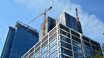 Glass building with transparent facade of the building and blue sky. Structural glass wall reflecting blue sky. Abstract modern architecture fragment. Contemporary architectural background. photo