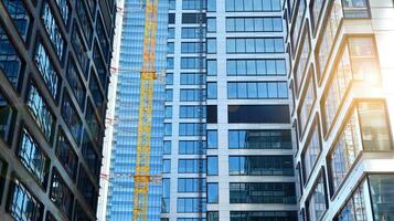 Glass building with transparent facade of the building and blue sky. Structural glass wall reflecting blue sky. Abstract modern architecture fragment. Contemporary architectural background. photo