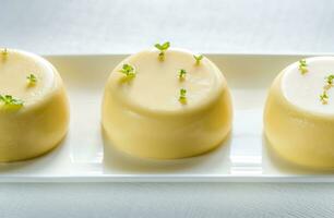 Vanilla puddings decorated with fresh mint photo