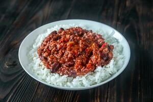 Chili con carne served with white rice photo