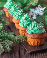 Decorated cupcakes with Christmas tree branch photo