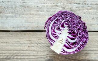 Red cabbage on the wooden background photo