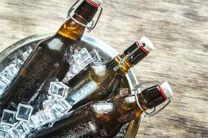 Bottles of beer in ice cubes photo