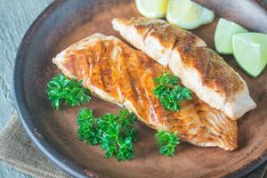 Roasted salmon steak with fresh parsley photo