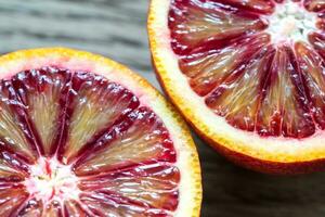 Red tangerines on the wooden background photo