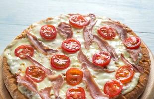 Pizza with cheese and prosciutto photo