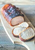 Pork loin wrapped in bacon photo