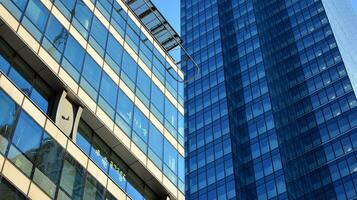 Glass building with transparent facade of the building and blue sky. Structural glass wall reflecting blue sky. Abstract modern architecture fragment. Contemporary architectural background. photo